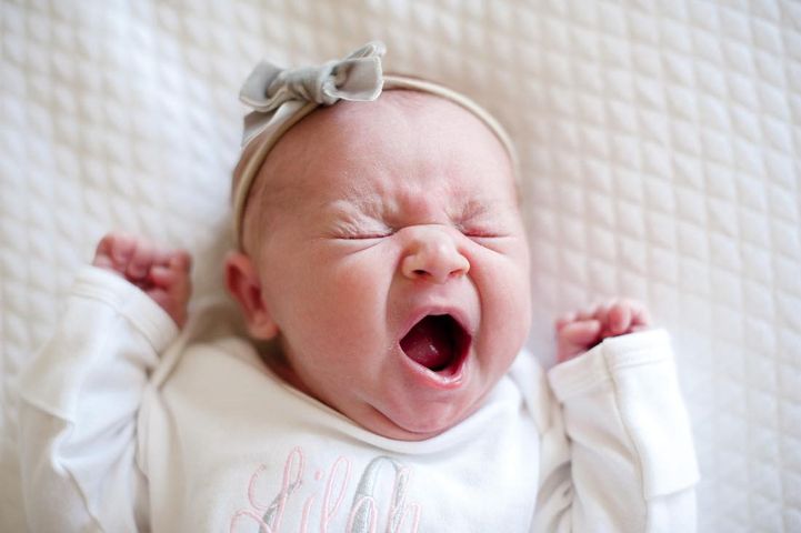 Young baby yawning